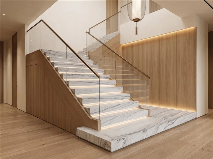 Luce Di Luna quartzite interior staircase with stone treads, matching risers, glass railings and warm wood side panels
