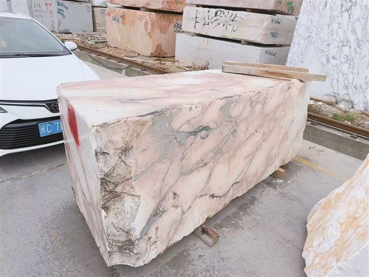 Portuguese Calacatta Rosa marble block presented for client approval before custom bathtub fabrication.