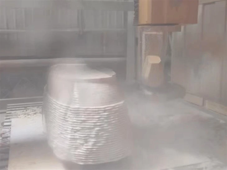 Five-axis CNC machining a client-approved Calacatta Rosa marble block into the specified bathtub geometry.