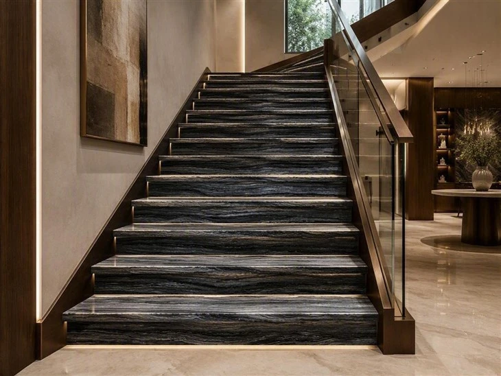 Zebra Black marble staircase treads and risers with mitered edges, glass railing and integrated step lighting