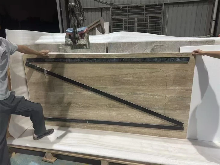 Large Italian Silver Travertine bathtub panel with a factory semi-cutout, protective film and temporary engineered-stone reinforcement strips for transport.