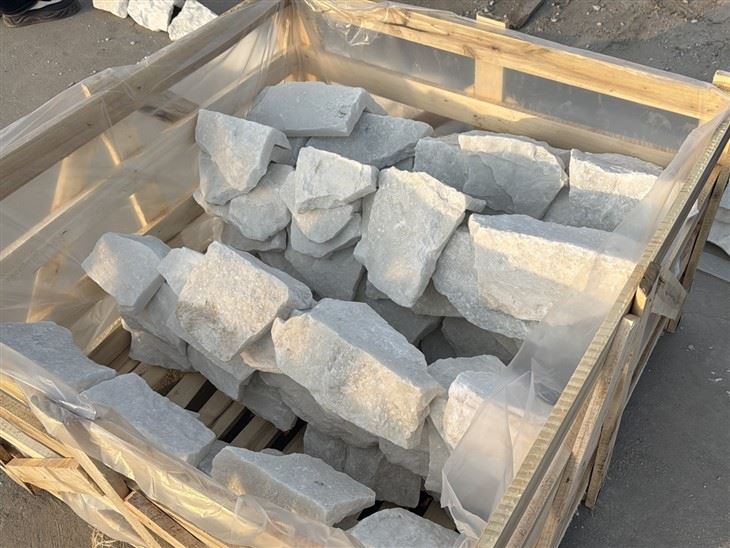 Natural White Quartzite loose random stone wall cladding corner pieces packed in a protective wooden crate for shipment