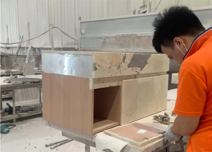 Factory pre-assembly with Patagonia Quartzite panels epoxy spot bonded to the custom wood cabinet.