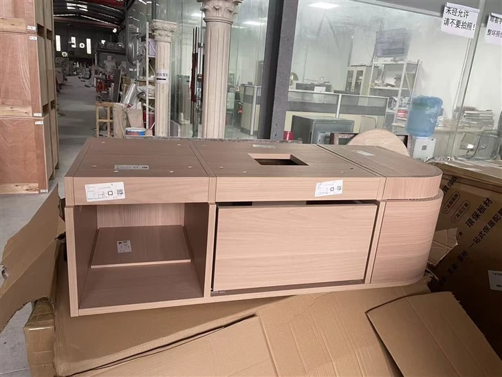 Custom multilayer solid-wood-board cabinet with drawers, plumbing access and a curved end before stone cladding.