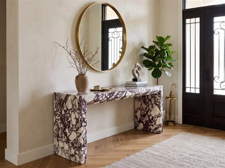 Calacatta Viola Marble console table with waterfall-style legs and dramatic burgundy veining in a refined entrance hall