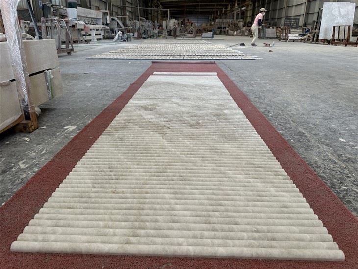 Factory dry layout of Taj Mahal Quartzite long fluted tiles for quality inspection and coordinated vein sequencing