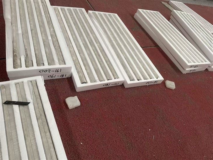 Finished Taj Mahal Quartzite long fluted tiles separated and protected in custom grooved foam trays