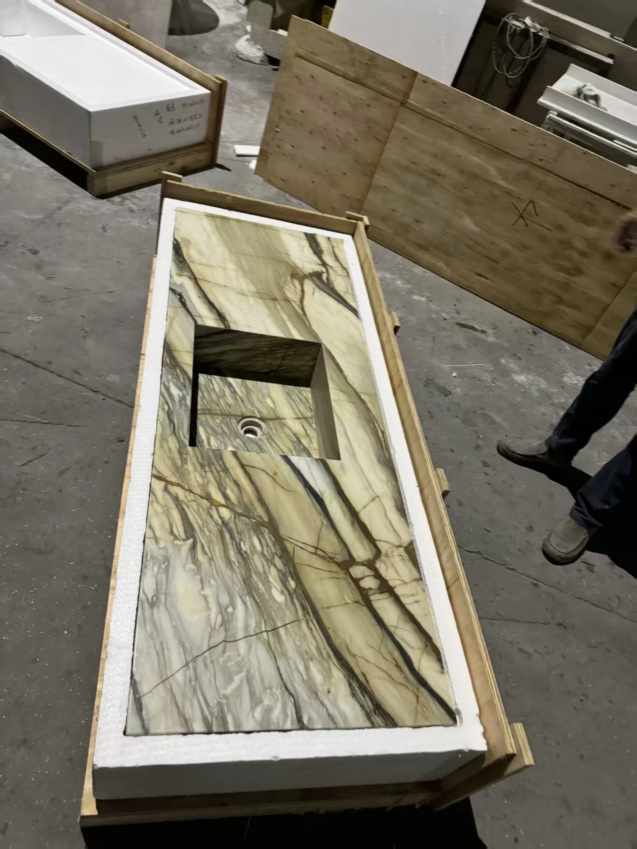 Cut-to-size stone countertop with integrated sink packed in a customized foam box with plywood cushioning and reinforced solid wood crate for safe export shipping Cut-to-size stone countertop with integrated sink packed in a customized foam box with plywood cushioning and reinforced solid wood crate for safe export shipping