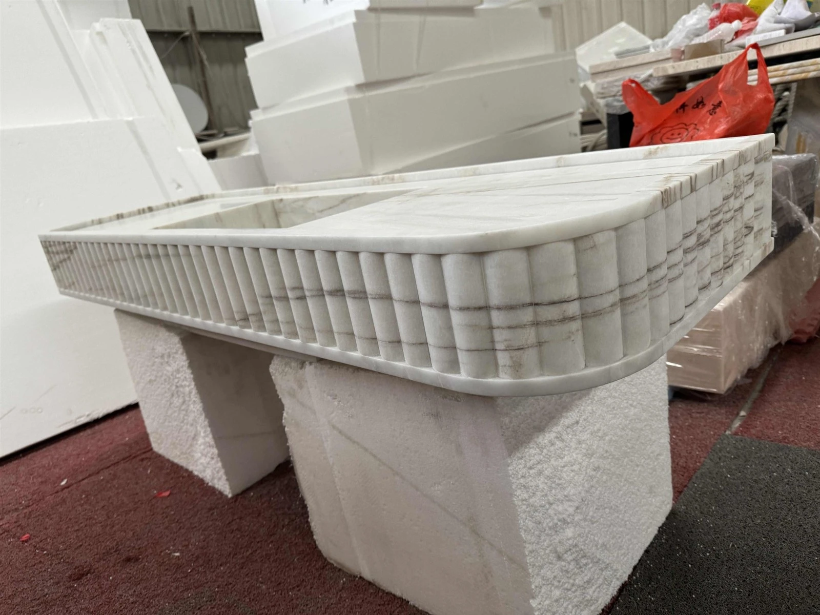 Dione Spider Marble integrated sink countertop showing fluted stone front detailing for a custom home project Dione Spider Marble integrated sink countertop showing fluted stone front detailing for a custom home project