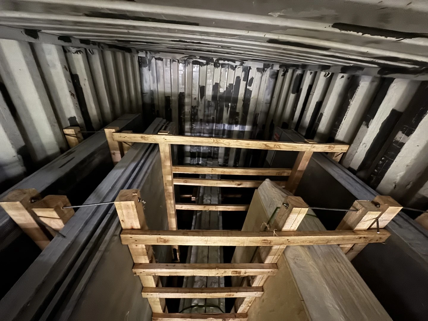 Internal timber bracing securing stone bundles and crates inside a 20-foot export container. Internal timber bracing securing stone bundles and crates inside a 20-foot export container.
