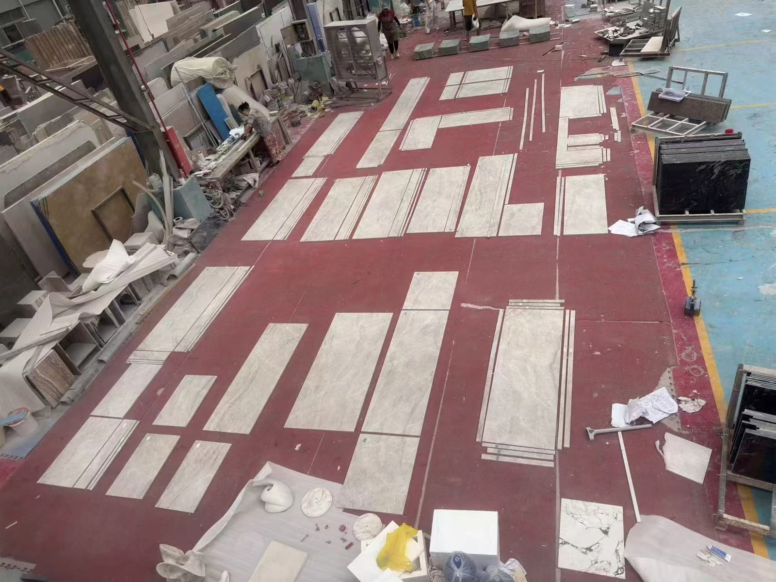 Cut Taj Mahal Quartzite countertop panels arranged on the factory floor according to the approved AutoCAD layout for color, vein and quality inspection. Cut Taj Mahal Quartzite countertop panels arranged on the factory floor according to the approved AutoCAD layout for color, vein and quality inspection.