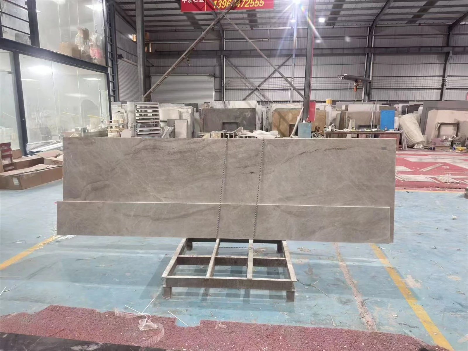 Grouped Taj Mahal Quartzite countertop panels stored on a metal frame after layout inspection and prepared for the next fabrication stage. Grouped Taj Mahal Quartzite countertop panels stored on a metal frame after layout inspection and prepared for the next fabrication stage.