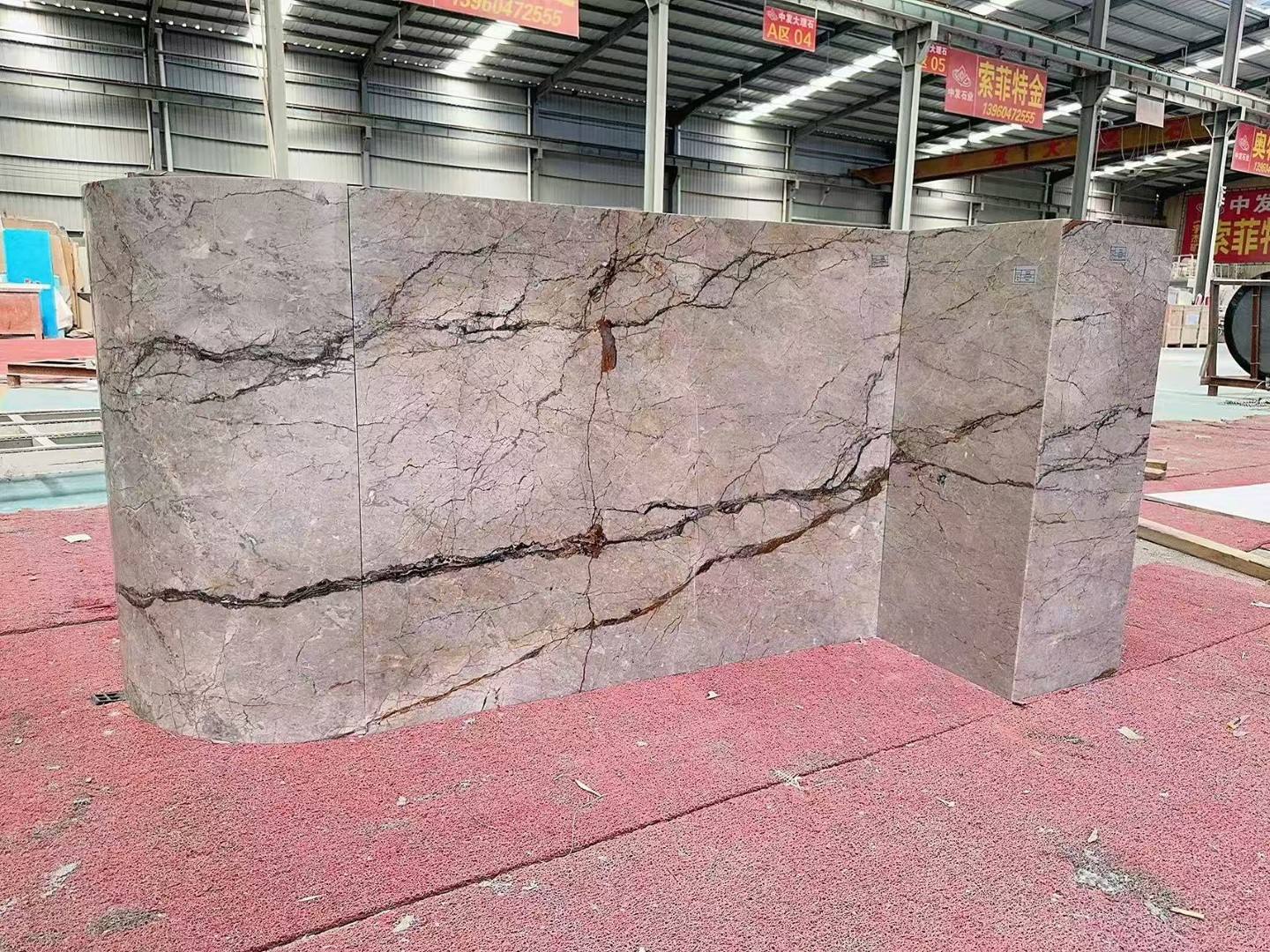 Factory fit-up of Silver Roots Marble panels on a kitchen island with a rounded end and coordinated veining. Factory fit-up of Silver Roots Marble panels on a kitchen island with a rounded end and coordinated veining.