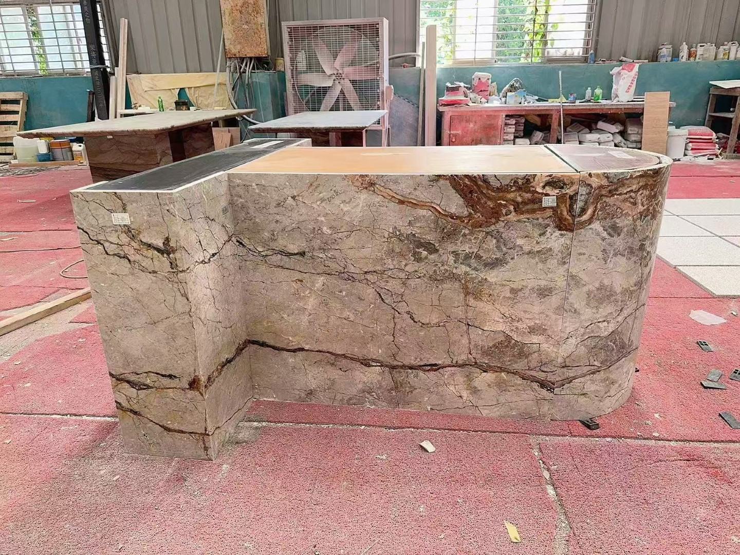 Reverse view of the kitchen island showing Silver Roots Marble panel joints and vein continuity around the curved end. Reverse view of the kitchen island showing Silver Roots Marble panel joints and vein continuity around the curved end.
