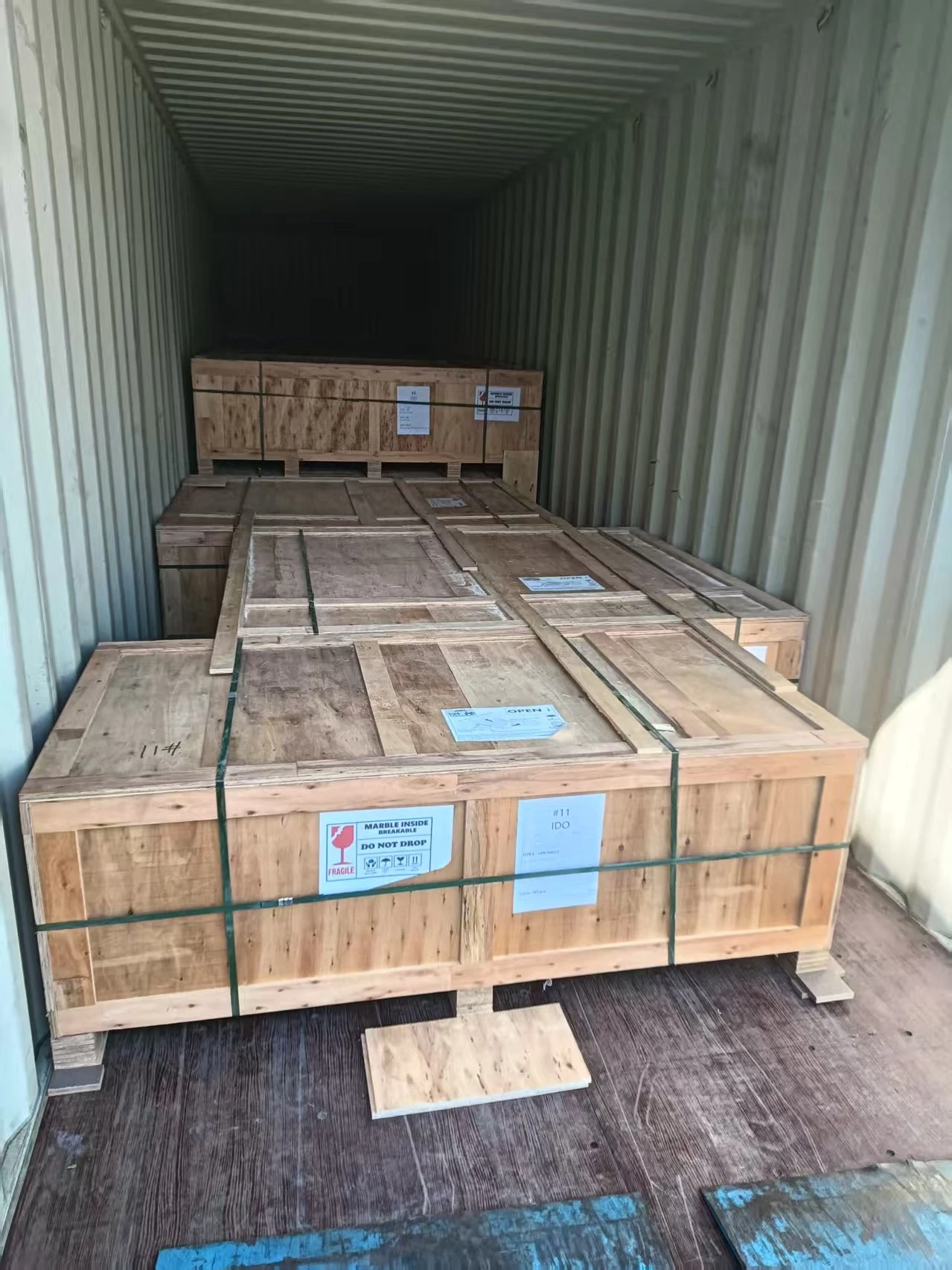Eleven export crates of white acrylic countertops with integrated sinks secured inside a 40-foot container after loading was completed. Eleven export crates of white acrylic countertops with integrated sinks secured inside a 40-foot container after loading was completed.