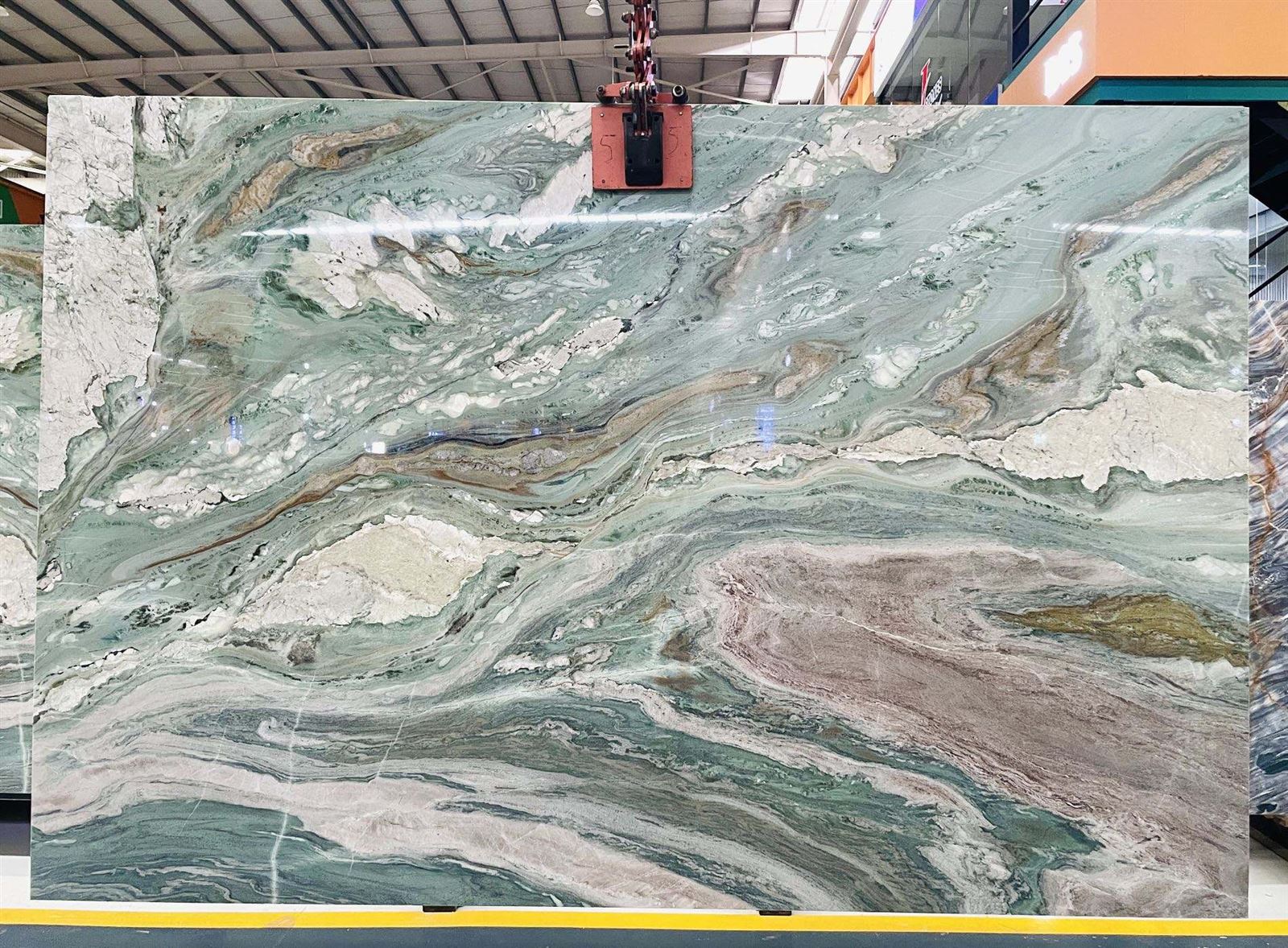 Polished Tiffany Green Quartzite slab with a soft green background and dramatic flowing white, gray, brown and blush veining displayed at Landiview Stone facility Polished Tiffany Green Quartzite slab with a soft green background and dramatic flowing white, gray, brown and blush veining displayed at Landiview Stone facility