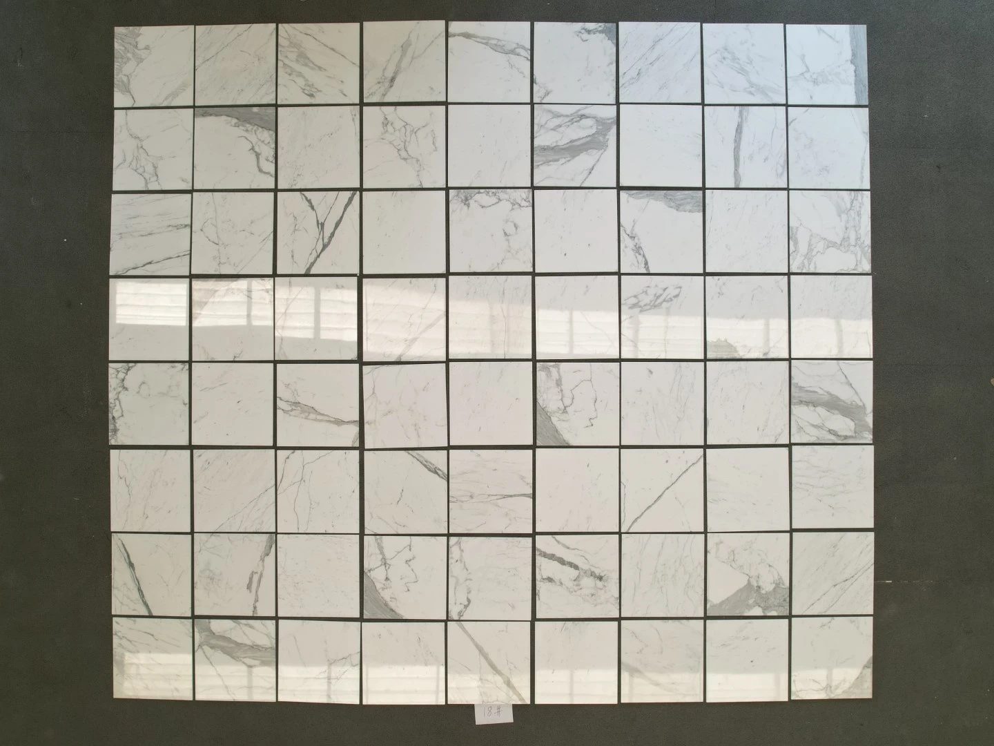 Factory dry layout inspection of polished Calacatta marble floor tiles before numbering and packing. Factory dry layout inspection of polished Calacatta marble floor tiles before numbering and packing.