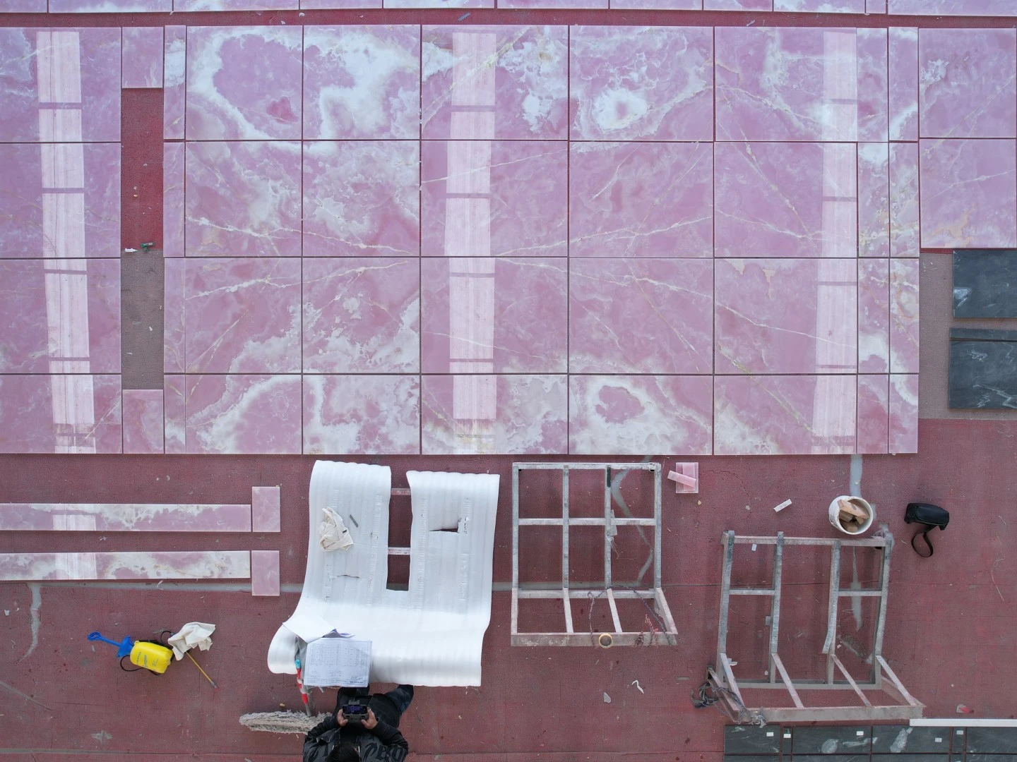 Factory dry layout of fabricated Pink Onyx tiles for color, vein continuity, piece condition and replacement review. Factory dry layout of fabricated Pink Onyx tiles for color, vein continuity, piece condition and replacement review.