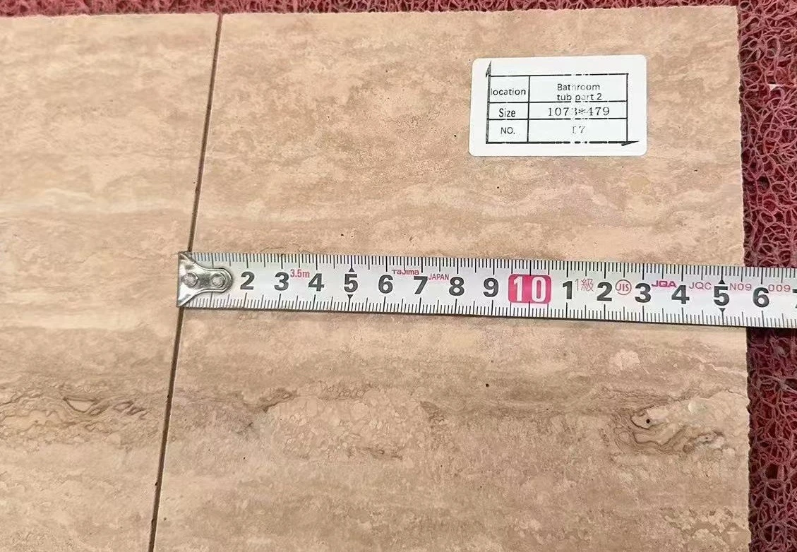 Measuring and checking a labeled Italian Silver Travertine bathtub panel before completing its large semi-cutout and transport reinforcement. Measuring and checking a labeled Italian Silver Travertine bathtub panel before completing its large semi-cutout and transport reinforcement.