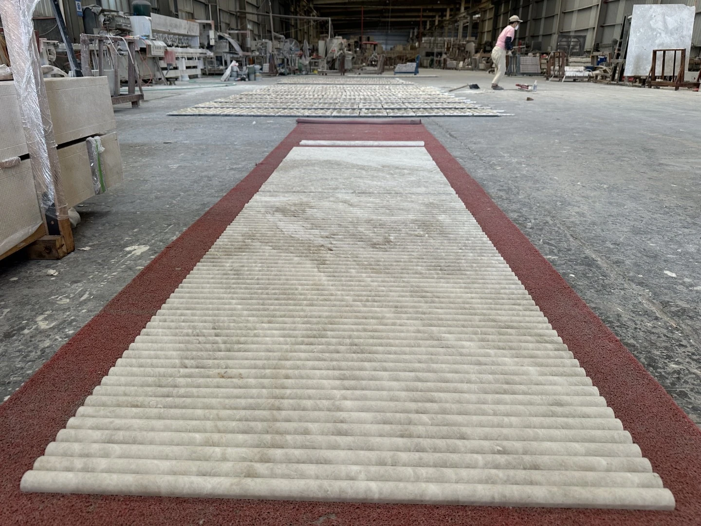 Factory dry layout of Taj Mahal Quartzite long fluted tiles for quality inspection and coordinated vein sequencing Factory dry layout of Taj Mahal Quartzite long fluted tiles for quality inspection and coordinated vein sequencing