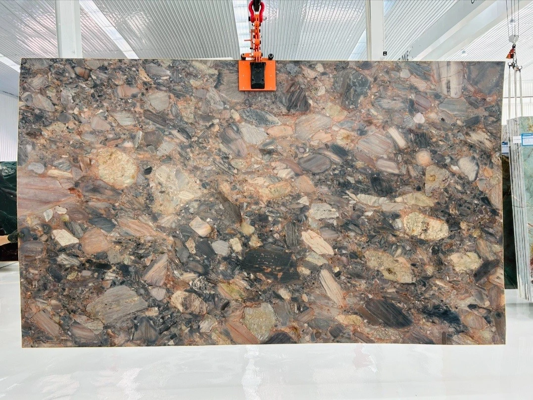 Honed Excalibur Quartzite slab featuring dramatic brecciated patterns in gray, brown, beige and muted pink tones displayed in Landiview Stone showroom Honed Excalibur Quartzite slab featuring dramatic brecciated patterns in gray, brown, beige and muted pink tones displayed in Landiview Stone showroom