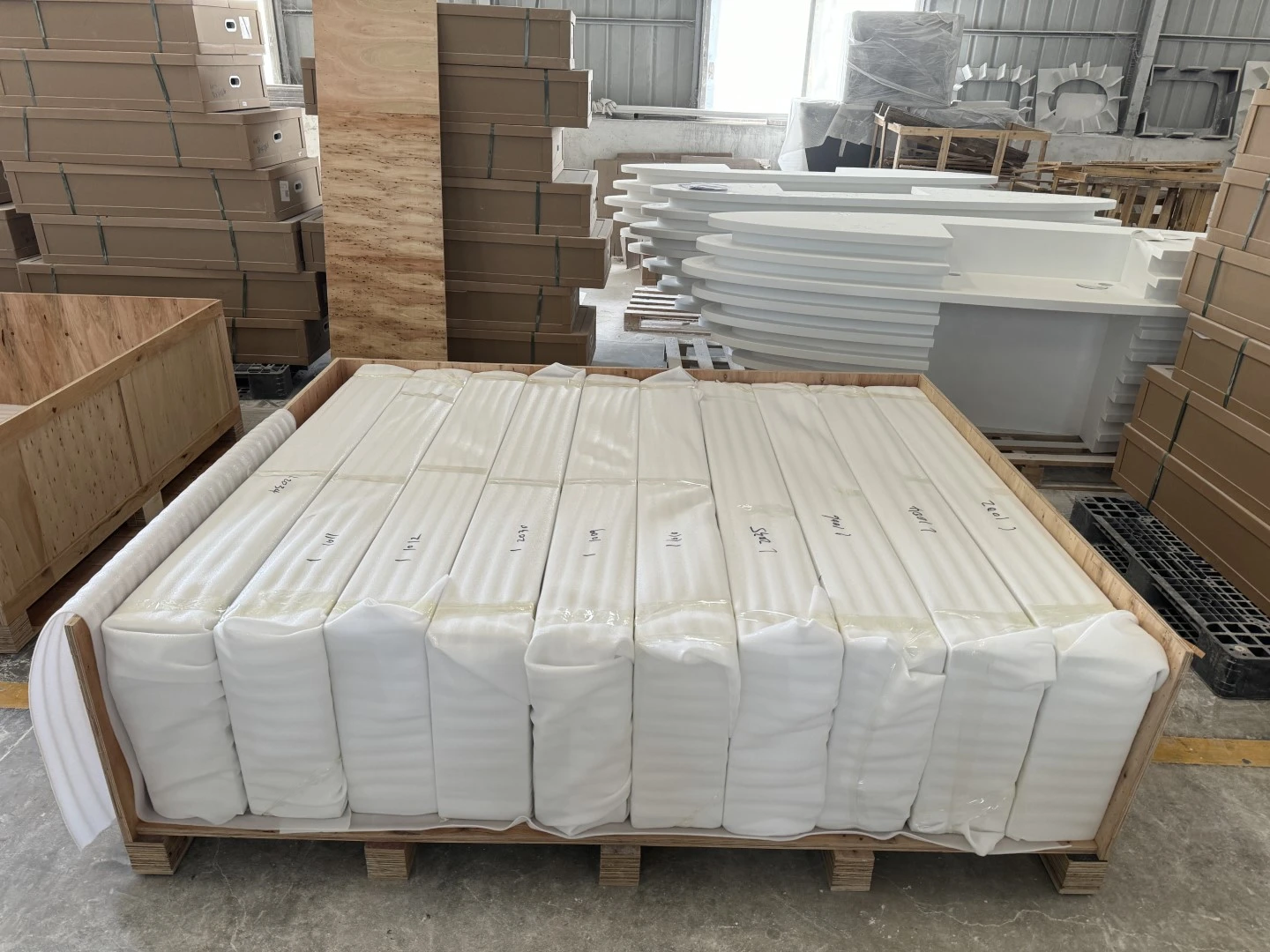 Individually numbered acrylic countertops wrapped in thick protective foam and separated inside a custom export crate. Individually numbered acrylic countertops wrapped in thick protective foam and separated inside a custom export crate.