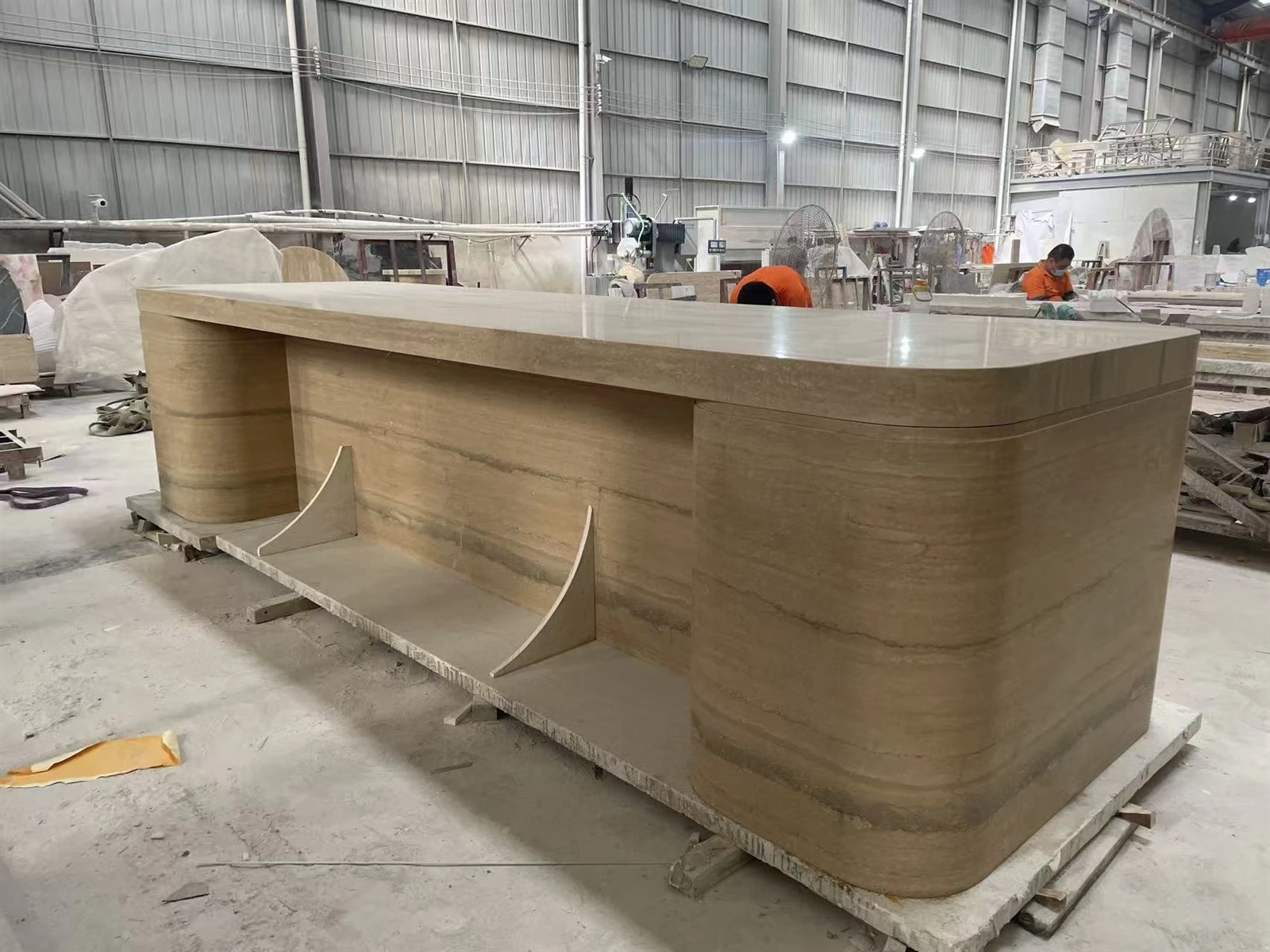 Factory trial assembly showing the kitchen island back, continuous Silver Travertine veining and rounded corners. Factory trial assembly showing the kitchen island back, continuous Silver Travertine veining and rounded corners.